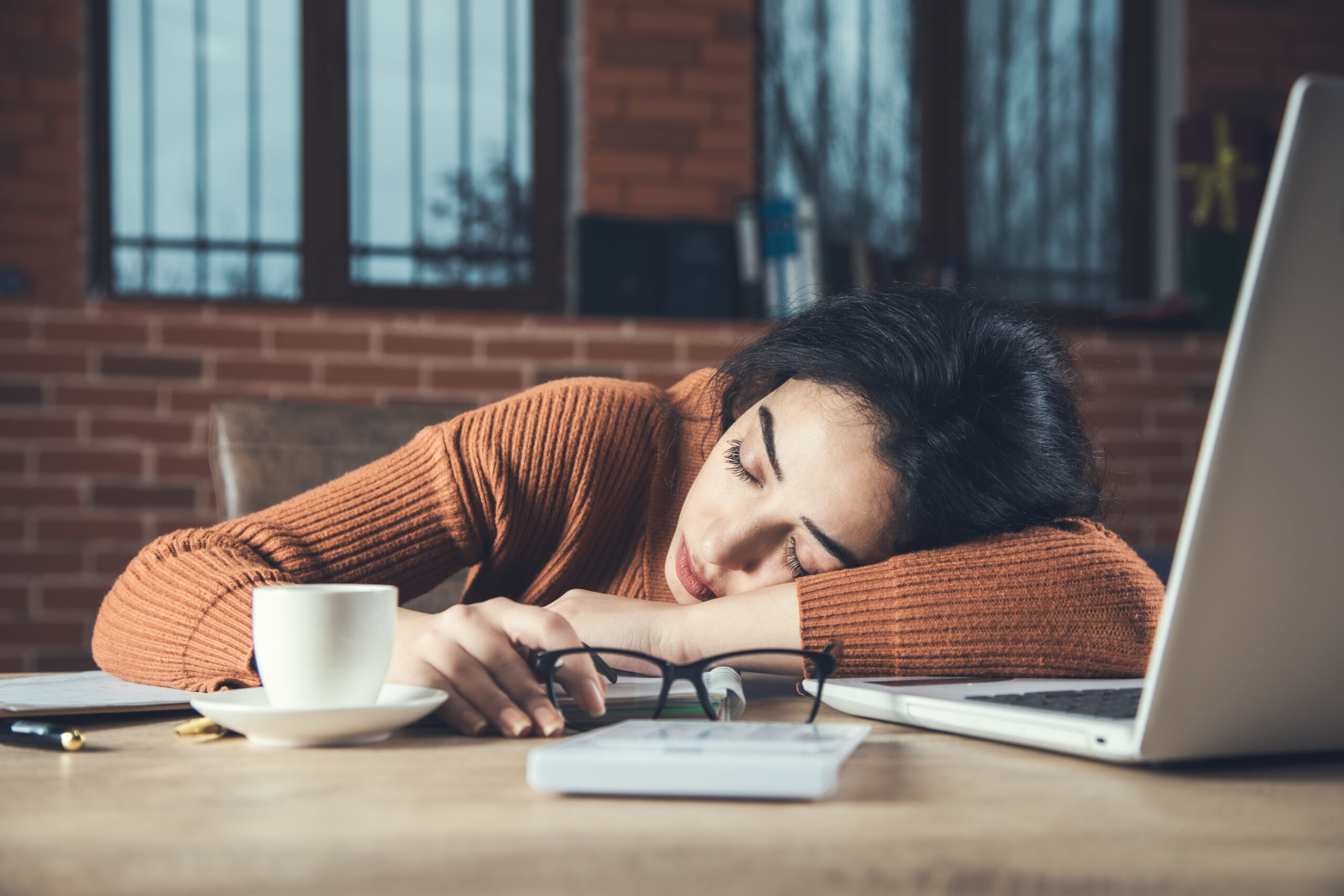 tired woman in office desk background